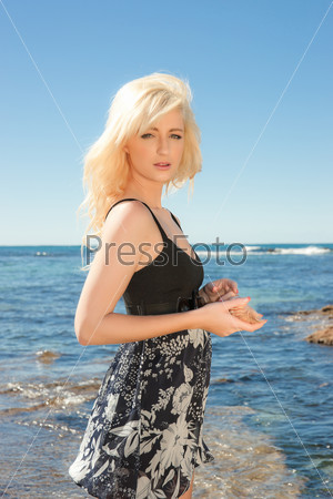 beautiful young woman with a sea shell