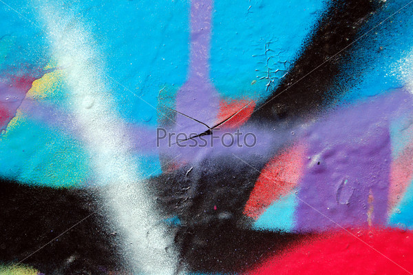 Wall covered with abstract chipped paint graffiti. Urban street art background.