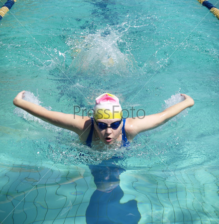 Swimming woman performing butterfly style