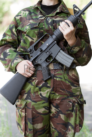 Female soldier witha gun on guard