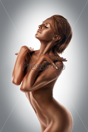 nude woman with metal skin posing like statue