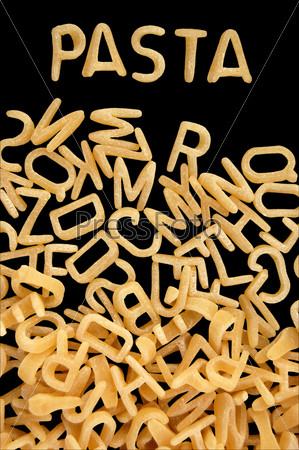 Spelling of the word pasta with alphabet soup letters. Kids food background.