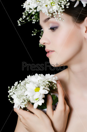 Portrait of the beautiful girl with flowers in hair