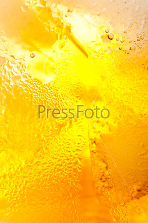 yellow wet tea background with water drops
