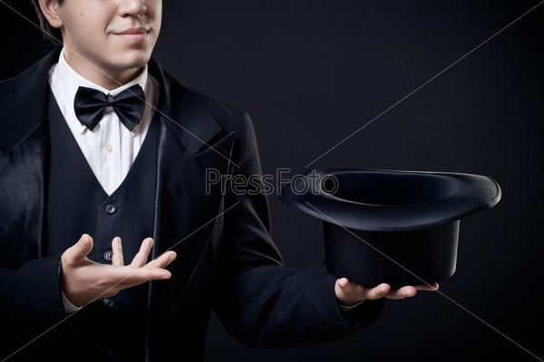 Closeup of magician showing tricks with top hat