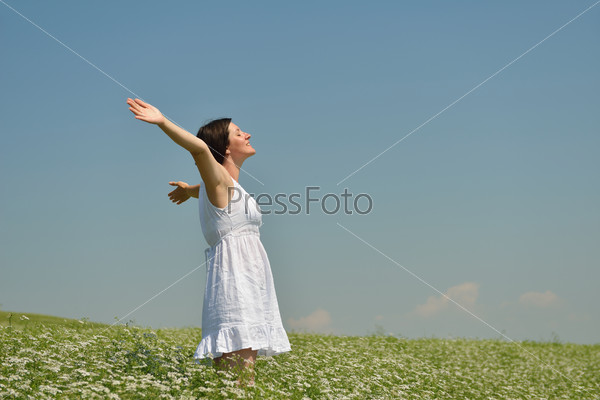 Young happy woman in green field