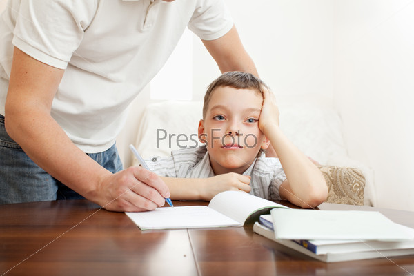 Father helping child do homework