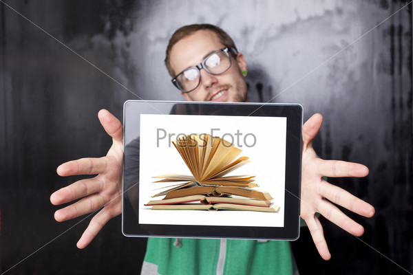 Good Looking Young Nerd Smart Guy Man Using Tablet Computer with book on screen