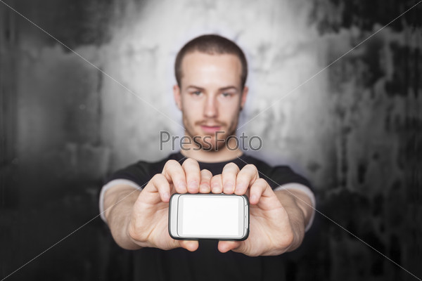 Men showing screen of mobile phone, black t-shirt and background, studio shot