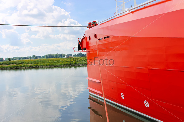 Bow of new red ship at the port