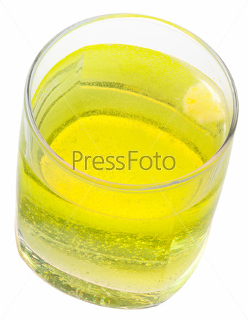 glass of yellow carbonated water with vitamin C isolated on white background