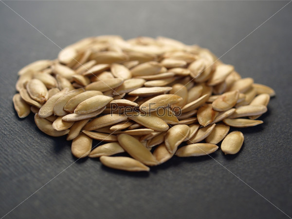 A heap of brown yellow melon seeds