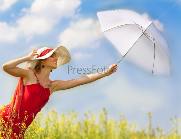 Beautiful asian girl under blue sky with umbrella in field.