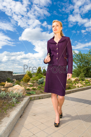 Beautiful Young Woman in suit on the street. In all growth.