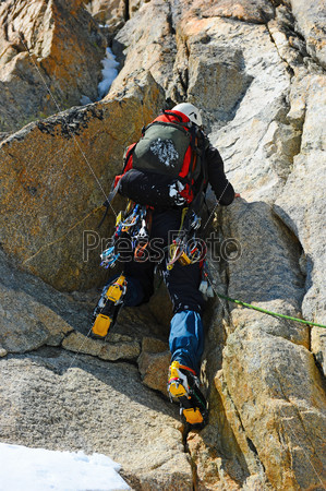 Mountaineer sport. A climber reaching the summit of the mountain