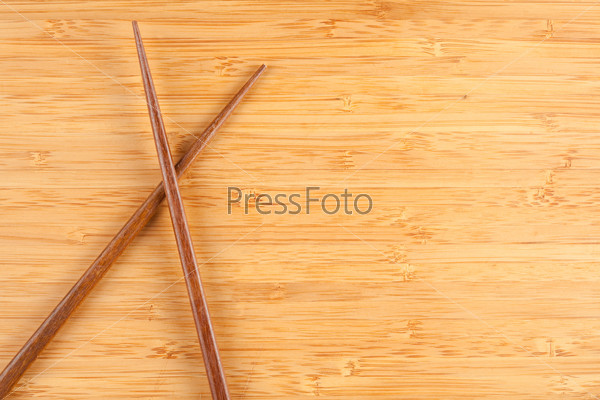 Bamboo Textured Surface Background with Chop Sticks and Plenty of Room For Text.