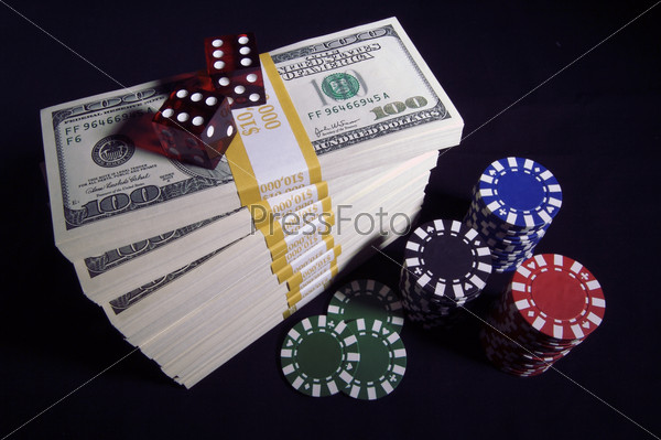 Stack of Ten Thousand Dollar Piles of One Hundred Dollar Bills, Red Dice & Poker Chips on a black background.