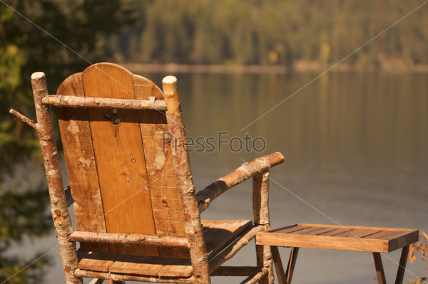 Tranquil Morning Lake Scene with Chair and Table, stock photo