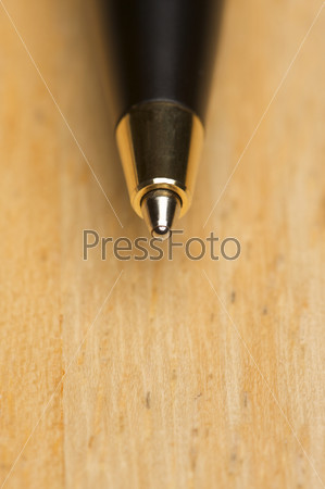 Ball Point Pen Macro on Wood Background with Narrow Depth of Field
