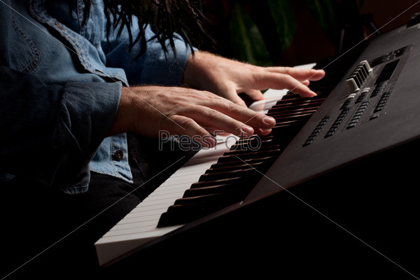 Male Pianist Performs on the Piano Keyboard