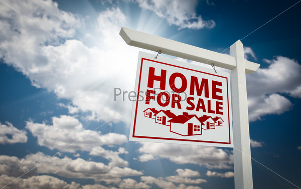 White and Red Home For Sale Real Estate Sign Over Beautiful Clouds and Blue Sky.