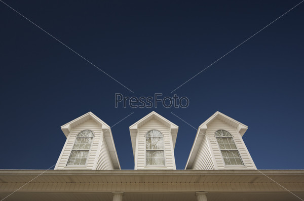 House Roof and Windows Against Deep Blue