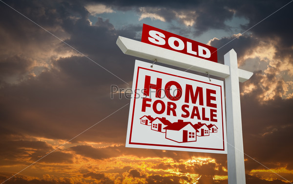 Red Sold Home For Sale Real Estate Sign Over Beautiful Clouds and Sunset Sky.