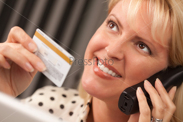 Woman on Her Laptop Holding Credit Card
