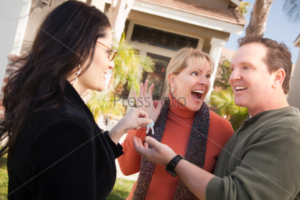 Real Estate Agent Handing keys to Couple