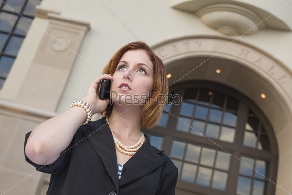 Proud Serious Young Pretty Businesswoman On Cell Phone Outside in Front of City Hall Building.