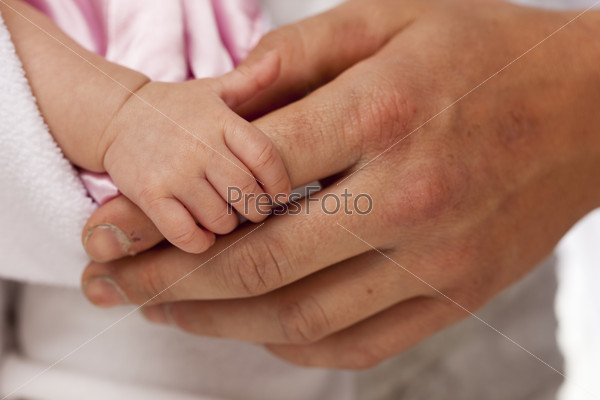 Baby Girl Hand Holding Rough Finger of Dad