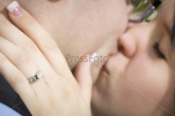 Female Hand with Engagement Ring Touching Fiance\'s Face