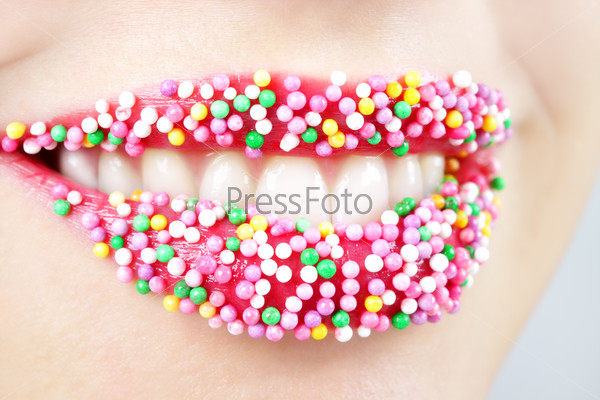 Womans lips with colored candy