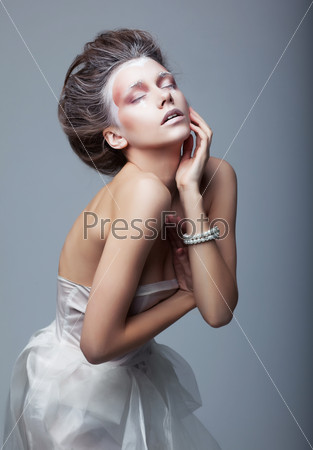 Woman actress in white dress acting on stage. Theater. Drama