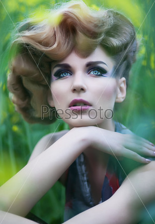 Summer meadow. Portrait of beautiful girl in field. Blurred background. Flowers. Poster design