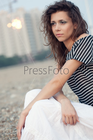 beautiful brunette   woman portrait sitting on ground