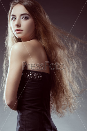 woman with long flying  hair  looks back