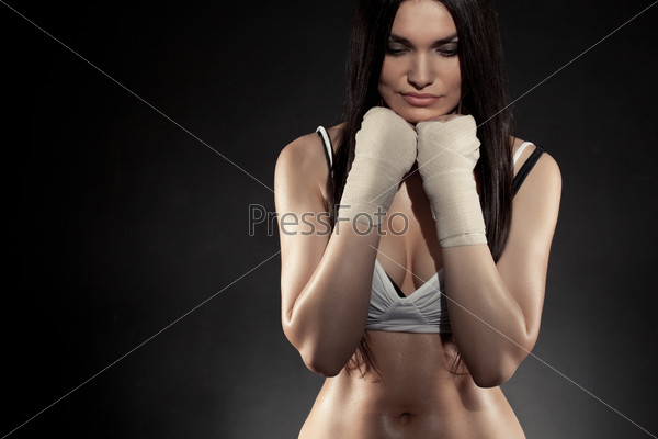 Beautiful woman boxer portrait wearing bandage on hands, stock photo