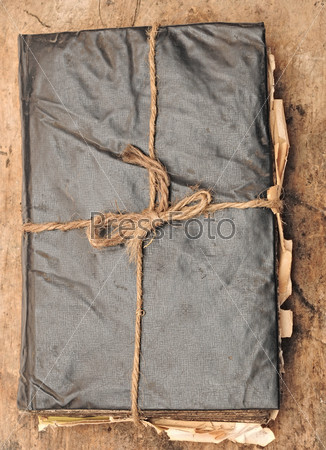 antique book and rope on wood