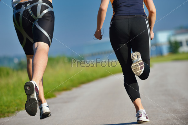 Young couple jogging in park at morning. Health and fitness concept, stock photo
