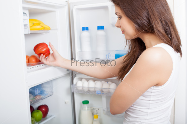 Woman searching in her fridge