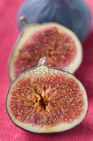 Close-up of a fig fruit cut in two halves, vertical shot