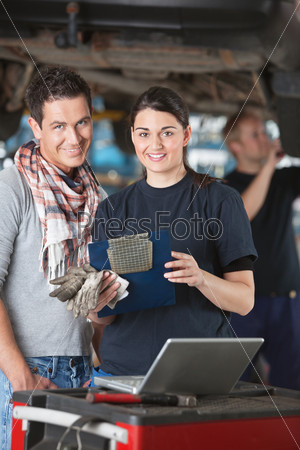 Female mechanic with customer