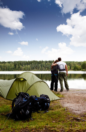 A summer camping lifestyle shot with a forest and lake landscape