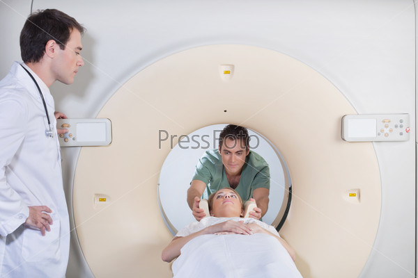 Male nurse preparing patient for CT test