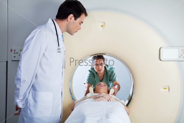 Doctor assisting the MRI scan with the technician in the laboratory