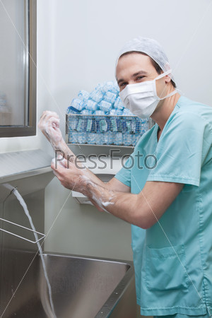 Male doctor washing hands