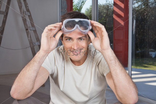 Portrait of a young smiling man with goggles