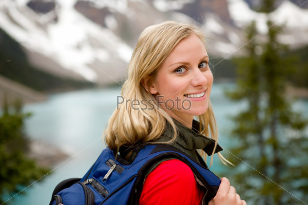A portrait of a pretty woman in front of a mountain landscape, Lake Moraine, Alberta, Canada
