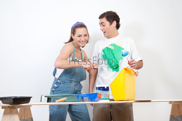 Woman painting color on her boyfriend\'s shirt